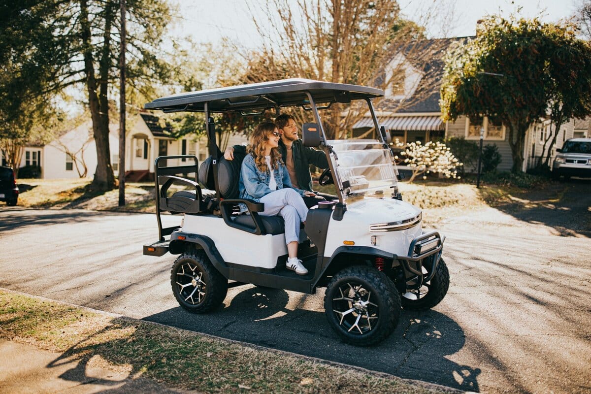 A couple riding a Denago Nomad XL at golden hour